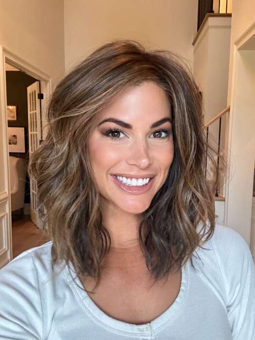 Katy C. @thewigeducator wearing WAVY DAY by RAQUEL WELCH WIGS in color RL8/29SS SHADED HAZELNUT | Warm Medium Brown Evenly Blended with Ginger Blonde with Dark Roots | window lighting
