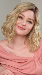 Model wearing EMMA by ENVY in SPARKLING-CHAMPAGNE | Medium Brown roots with overall Strawberry Blonde base and soft Golden Blonde highlights