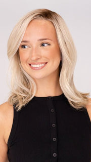 Model is wearing DAZZLING WAVEZ by RENE OF PARIS in color MILKY OPAL R | A Blend of Creamy Blonde and White Blonde Rooted with Warm Brown