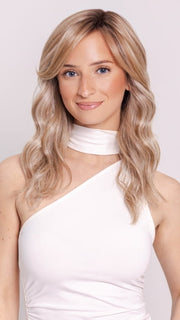 Ava wearing KELLY by BELLETRESS in BUTTERCAKE BLONDE-R | A neutral-warm blonde blend featuring light brown, ash, and lightest blonde tones with natural-looking darker roots for added depth and realism.