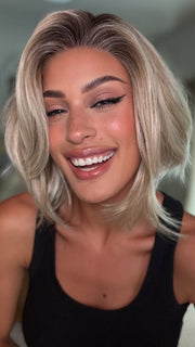 Roxie wearing MIRA by AMORE in SEA SALT BLOND R | A perfect mixture of cool, icy-blond and warm-dark blond. The rich brown root tone enhances the modern appearance.
