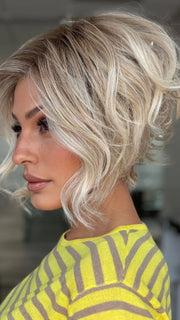 Roxie wearing LOS ANGELES by BELLETRESS in CRUSHED ALMOND BLONDE R | A soft Neutral Light Blonde with a Light and Medium Blended Root Color.