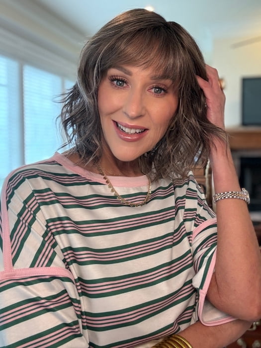 Eileen wearing TERRA by AMORE in BRONDE-R | Dark brown and natural medium blond tones are mixed together and shaded with medium dark brown roots for a realistic appearance.
