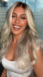 Roxie wearing ESME by RENE OF PARIS in BILLIONAIRE-BLOND | A Rich Mocha Root melting into Beige, Ash, and Cream Blond tones. Face-framing cream and White Blond highlights