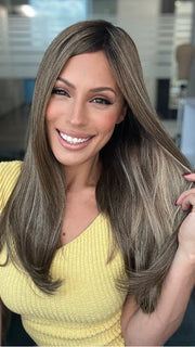 Roxie is wearing UNMATCHED 18" by RAQUEL WELCH in SS9/24 ICED CAFÉ LATTE | Dark Brown shaded with Golden Brown