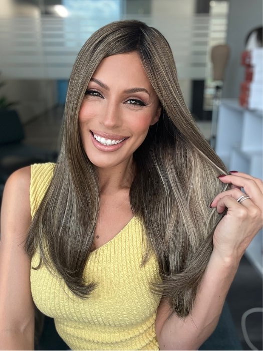 Roxie is wearing UNMATCHED 18" by RAQUEL WELCH in SS9/24 ICED CAFÉ LATTE | Dark Brown shaded with Golden Brown