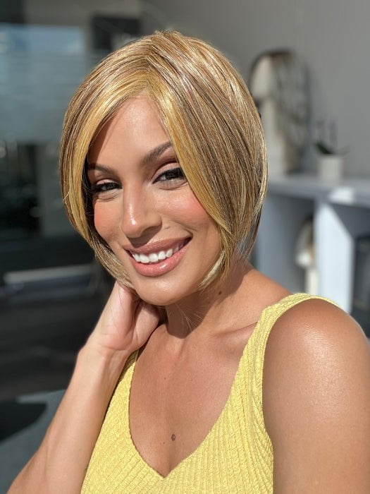 Roxie is wearing TOP BILLING 8" by RAQUEL WELCH in RL29/25 GOLDEN RUSSET | Ginger Blonde Evenly Blended with Medium Golden Blonde