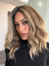 Model is wearing COREY by ENVY in color HONEY BREEZE | A blend of Cool, Honey Blonde and Multi-Dimensional Medium Brown with Darker Brown Roots
