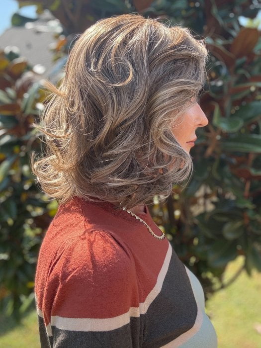 Eileen wearing HELSINKI by BELLETRESS in MACADAMIA LATTE R | A combination of Medium and Light Brown, highlighted with Light Gold Blonde, and a mixture of Ash Blonde and Light Gold Blonde, Rooted with Medium and Light Brown