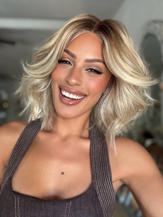 Roxie wearing STEAL THE SHOW by RAQUEL WELCH in SS19/23 SHADED BISCUIT | Cool Platinum Blonde with subtle highlights and Medium Brown roots