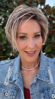 Eileen wearing SPENCER by BELLETRESS in BUTTERCAKE BLONDE-R | A neutral-warm blonde blend featuring light brown, ash, and lightest blonde tones with natural-looking darker roots for added depth and realism.