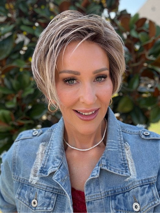 Eileen wearing SPENCER by BELLETRESS in BUTTERCAKE BLONDE-R | A neutral-warm blonde blend featuring light brown, ash, and lightest blonde tones with natural-looking darker roots for added depth and realism.