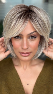 Roxie wearing WINTOUR by BELLETRESS in COOL CHAI BLONDE-R | A balanced cool blonde with softly contrasted darker roots, a fresh twist on classic blonde tones.