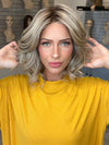 Madeline wearing ISSEY by BELLETRESS in SPARKLING CHAMPAGNE R | Medium Ash Brown roots transition into Shimmering Champagne Blonde characterized by Pale Golden Hues with subtle Ivory and Platinum undertones reminiscent of a sparkling glass of bubbly