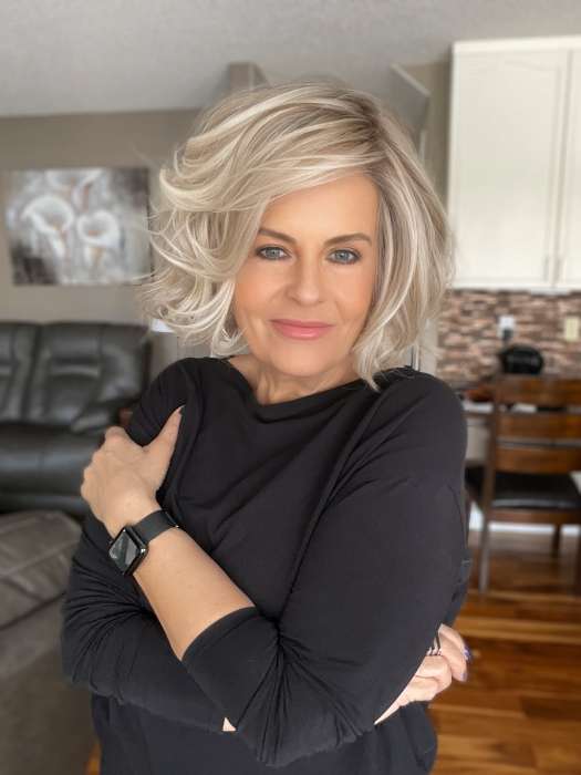 Donna @style.me.ageless wearing FLIRT ALERT by RAQUEL WELCH WIGS in color RL19/23SS SHADED BISCUIT | Light Ash Blonde Evenly Blended with Cool Platinum Blonde with Dark Roots