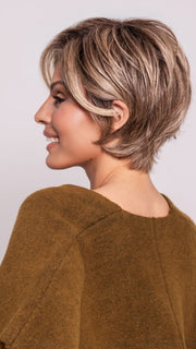 Roxie is wearing POSH PREMIERE by RAQUEL WELCH in RL12/22SS SHADED CAPPUCCINO | Light Golden Brown Evenly Blended with Cool Platinum Blonde Highlights with Dark Roots