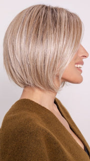 Roxie wearing BECKHAM by BELLETRESS in BUTTERCAKE BLONDE-R | A neutral-warm blonde blend featuring light brown, ash, and lightest blonde tones with natural-looking darker roots for added depth and realism.