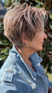 Eileen wearing SPENCER by BELLETRESS in BUTTERCAKE BLONDE-R | A neutral-warm blonde blend featuring light brown, ash, and lightest blonde tones with natural-looking darker roots for added depth and realism.