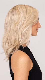Model is wearing DAZZLING WAVEZ by RENE OF PARIS in color MILKY OPAL R | A Blend of Creamy Blonde and White Blonde Rooted with Warm Brown