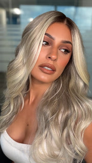 Roxie wearing ESME by RENE OF PARIS in BILLIONAIRE-BLOND | A Rich Mocha Root melting into Beige, Ash, and Cream Blond tones. Face-framing cream and White Blond highlights