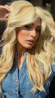 Roxie is wearing California Beach Waves by TressAllure in shade 223/23C | Light Golden Blonde