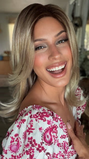 Roxie wearing HARLOW by NORIKO in MELTED-MARSHMALLOW | Subtly Warm Dark Sandy Blonde Blend with Medium Brown Roots and Light Ash Blonde Tips and Highlights