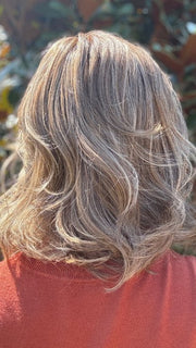 Eileen wearing HELSINKI by BELLETRESS in MACADAMIA LATTE R | A combination of Medium and Light Brown, highlighted with Light Gold Blonde, and a mixture of Ash Blonde and Light Gold Blonde, Rooted with Medium and Light Brown