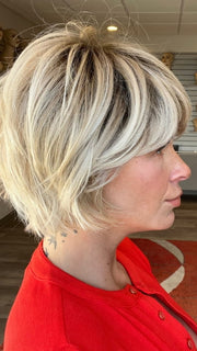 Madeline wearing TOLEDO by BELLETRESS in CRUSHED ALMOND BLONDE R | A soft Neutral Light Blonde with a Light and Medium Blended Root Color.