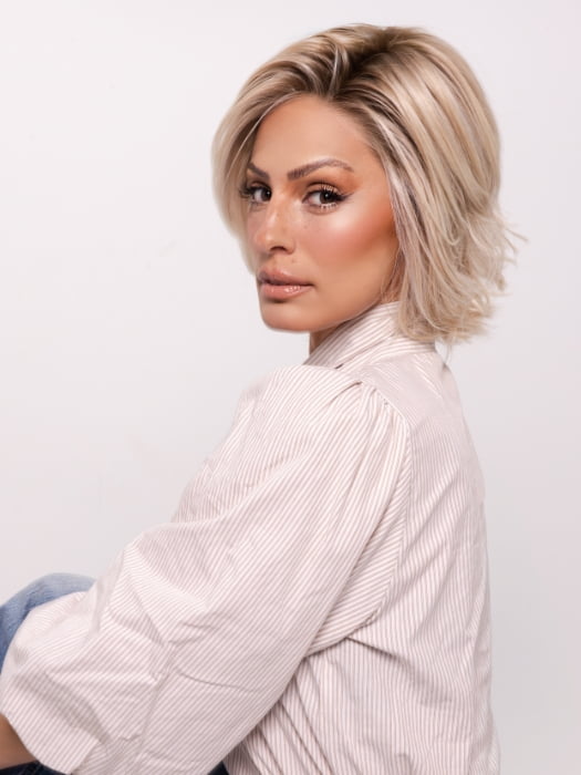 Roxie wearing ALICANTE by BELLETRESS in CRUSHED ALMOND BLONDE R | A soft Neutral Light Blonde with a Light and Medium Blended Root Color.