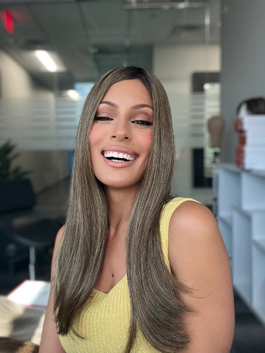 Roxie is wearing UNMATCHED 18" by RAQUEL WELCH in SS9/24 ICED CAFÉ LATTE | Dark Brown shaded with Golden Brown