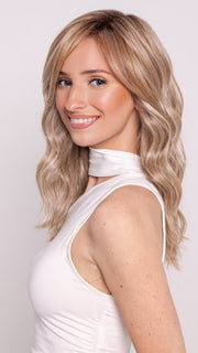 Ava wearing KELLY by BELLETRESS in BUTTERCAKE BLONDE-R | A neutral-warm blonde blend featuring light brown, ash, and lightest blonde tones with natural-looking darker roots for added depth and realism.