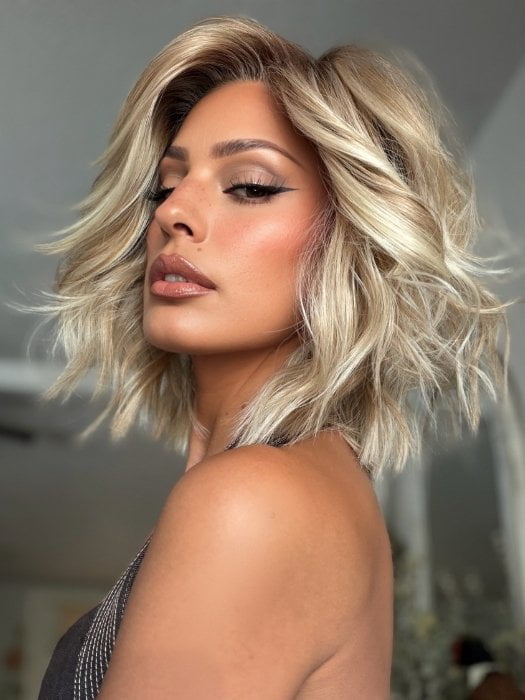 Roxie wearing STEAL THE SHOW by RAQUEL WELCH in SS19/23 SHADED BISCUIT | Cool Platinum Blonde with subtle highlights and Medium Brown roots