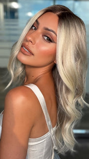 Roxie wearing ESME by RENE OF PARIS in BILLIONAIRE-BLOND | A Rich Mocha Root melting into Beige, Ash, and Cream Blond tones. Face-framing cream and White Blond highlights