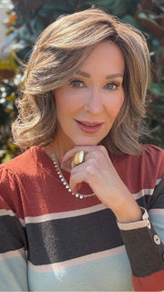 Eileen wearing HELSINKI by BELLETRESS in MACADAMIA LATTE R | A combination of Medium and Light Brown, highlighted with Light Gold Blonde, and a mixture of Ash Blonde and Light Gold Blonde, Rooted with Medium and Light Brown