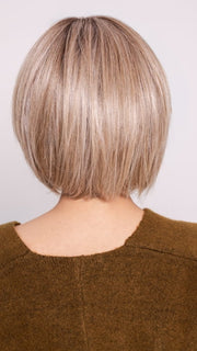 Roxie wearing BECKHAM by BELLETRESS in BUTTERCAKE BLONDE-R | A neutral-warm blonde blend featuring light brown, ash, and lightest blonde tones with natural-looking darker roots for added depth and realism.