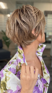 Roxie is wearing POSH PREMIERE by RAQUEL WELCH in RL12/22SS SHADED CAPPUCCINO | Light Golden Brown Evenly Blended with Cool Platinum Blonde Highlights with Dark Roots