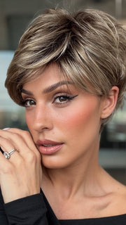 Roxie wearing SPARKLE PETITE by RAQUEL WELCH in SS12/22 SHADED CAPPUCCINO | Light Golden Brown Evenly Blended with Cool Platinum Blonde Highlights and Dark Roots
