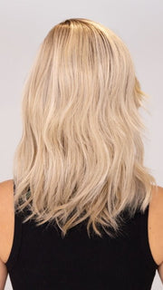Model is wearing DAZZLING WAVEZ by RENE OF PARIS in color MILKY OPAL R | A Blend of Creamy Blonde and White Blonde Rooted with Warm Brown