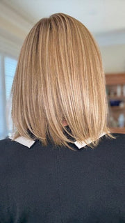 Eileen wearing PAIGE PETITE by ENVY in SPARKLING CHAMPAGNE | Medium Brown roots with overall Strawberry Blonde base and soft Golden Blonde highlights