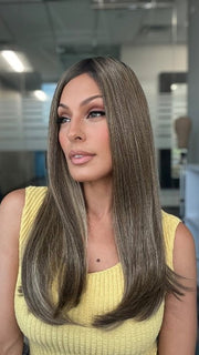 Roxie is wearing UNMATCHED 18" by RAQUEL WELCH in SS9/24 ICED CAFÉ LATTE | Dark Brown shaded with Golden Brown