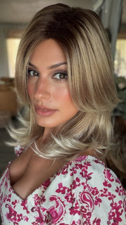 Roxie wearing HARLOW by NORIKO in MELTED-MARSHMALLOW | Subtly Warm Dark Sandy Blonde Blend with Medium Brown Roots and Light Ash Blonde Tips and Highlights