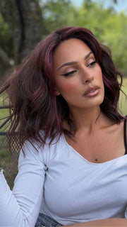 Roxie wearing SMOOTH WAVEZ by RENE OF PARIS in DUSTY-ROSE | Medium Coral Red Base with Dark Brown Roots