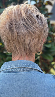 Eileen wearing SPENCER by BELLETRESS in BUTTERCAKE BLONDE-R | A neutral-warm blonde blend featuring light brown, ash, and lightest blonde tones with natural-looking darker roots for added depth and realism.
