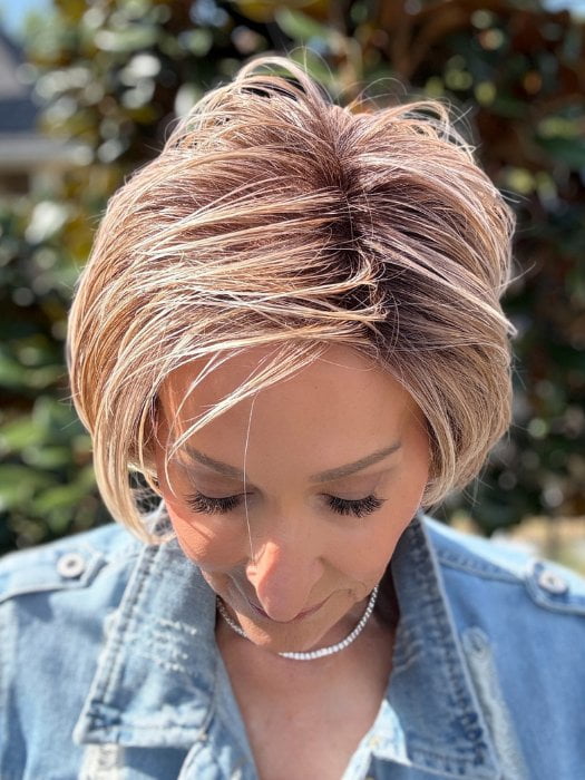 Eileen wearing SPENCER by BELLETRESS in BUTTERCAKE BLONDE-R | A neutral-warm blonde blend featuring light brown, ash, and lightest blonde tones with natural-looking darker roots for added depth and realism.
