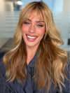 Roxie wearing POSH WAVEZ by RENE OF PARIS in Bronzed Honey-R | A perfect blend of rich, warm golden blond and medium chocolate brown tones, complemented by a dark chocolate root that adds a luxurious, dimensional effect.