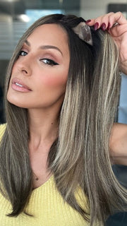 Roxie is wearing UNMATCHED 18" by RAQUEL WELCH in SS9/24 ICED CAFÉ LATTE | Dark Brown shaded with Golden Brown