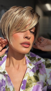 Roxie is wearing POSH PREMIERE by RAQUEL WELCH in RL12/22SS SHADED CAPPUCCINO | Light Golden Brown Evenly Blended with Cool Platinum Blonde Highlights with Dark Roots