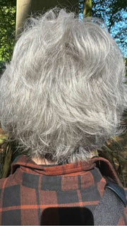 Mel B. @mels.be.ageless wearing VOLTAGE by RAQUEL WELCH WIGS in color RL51/61 ICED GRANITA | Lightest Grey Progresses to a Deep Grey at the Nape