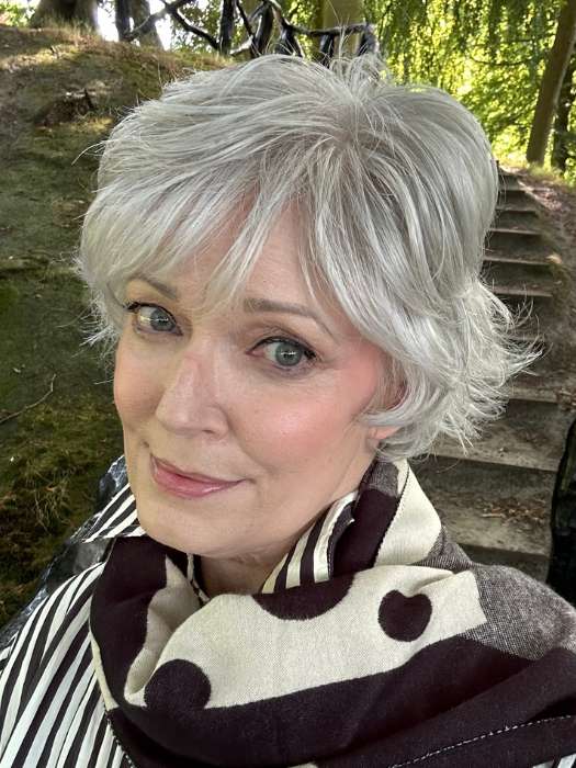 Mel B. @mels.be.ageless wearing VOLTAGE ELITE by RAQUEL WELCH WIGS in color R56/60 SILVER MIST | Lightest Gray with 20% Medium Brown Evenly Blended with Pure White