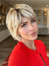 Madeline wearing TOLEDO by BELLETRESS in CRUSHED ALMOND BLONDE R | A soft Neutral Light Blonde with a Light and Medium Blended Root Color.